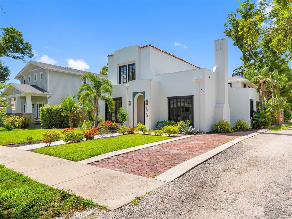 1570 48th Avenue North St. Petersburg, FL 33703 - Photo 5 of 75 a front view of a house with garden
