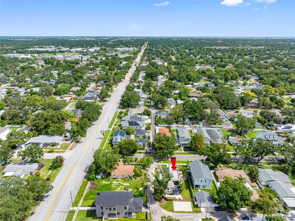 1570 48th Avenue North St. Petersburg, FL 33703 - Photo 70 of 75 an aerial view of residential houses with outdoor space and trees