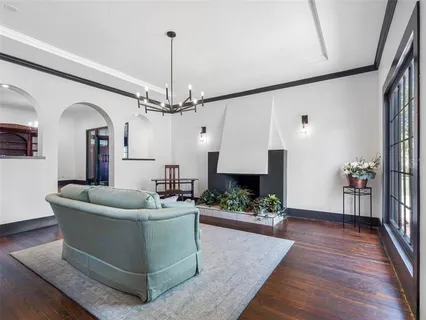 a living room with furniture and a chandelier