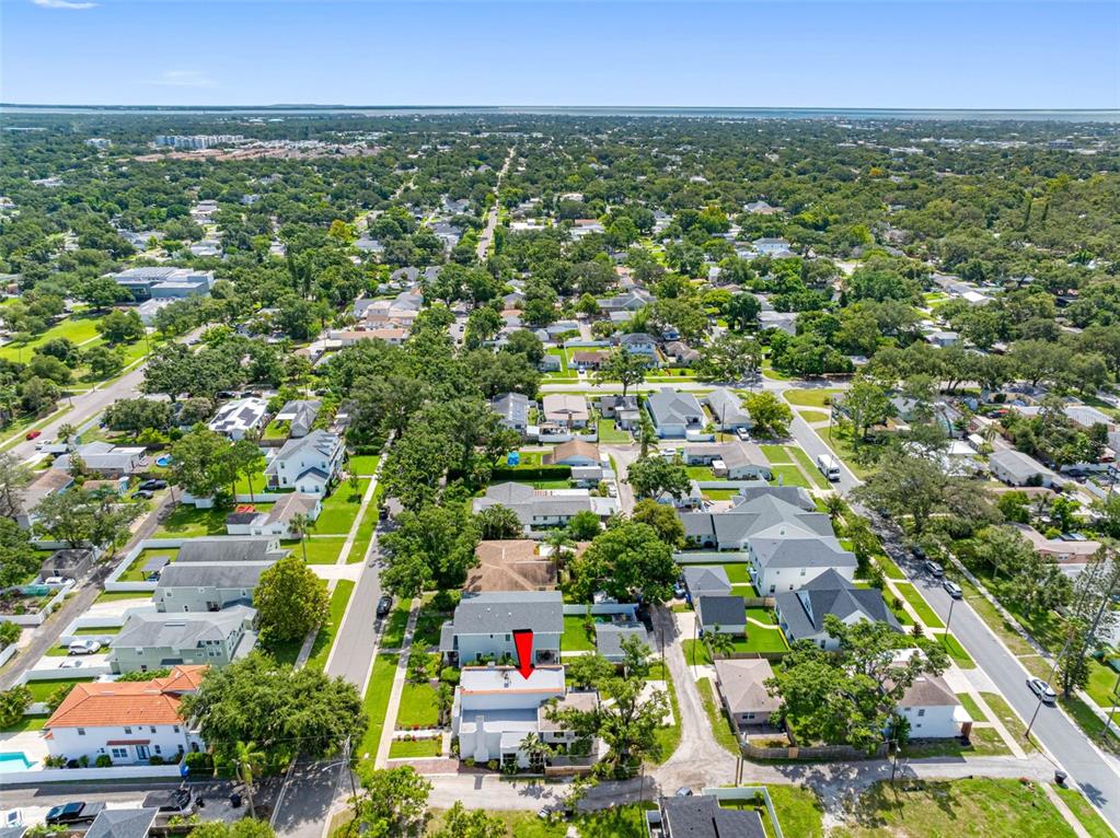 1570 48th Avenue North St. Petersburg, FL 33703 - Photo 72 of 75 an aerial view of residential houses with outdoor space and trees