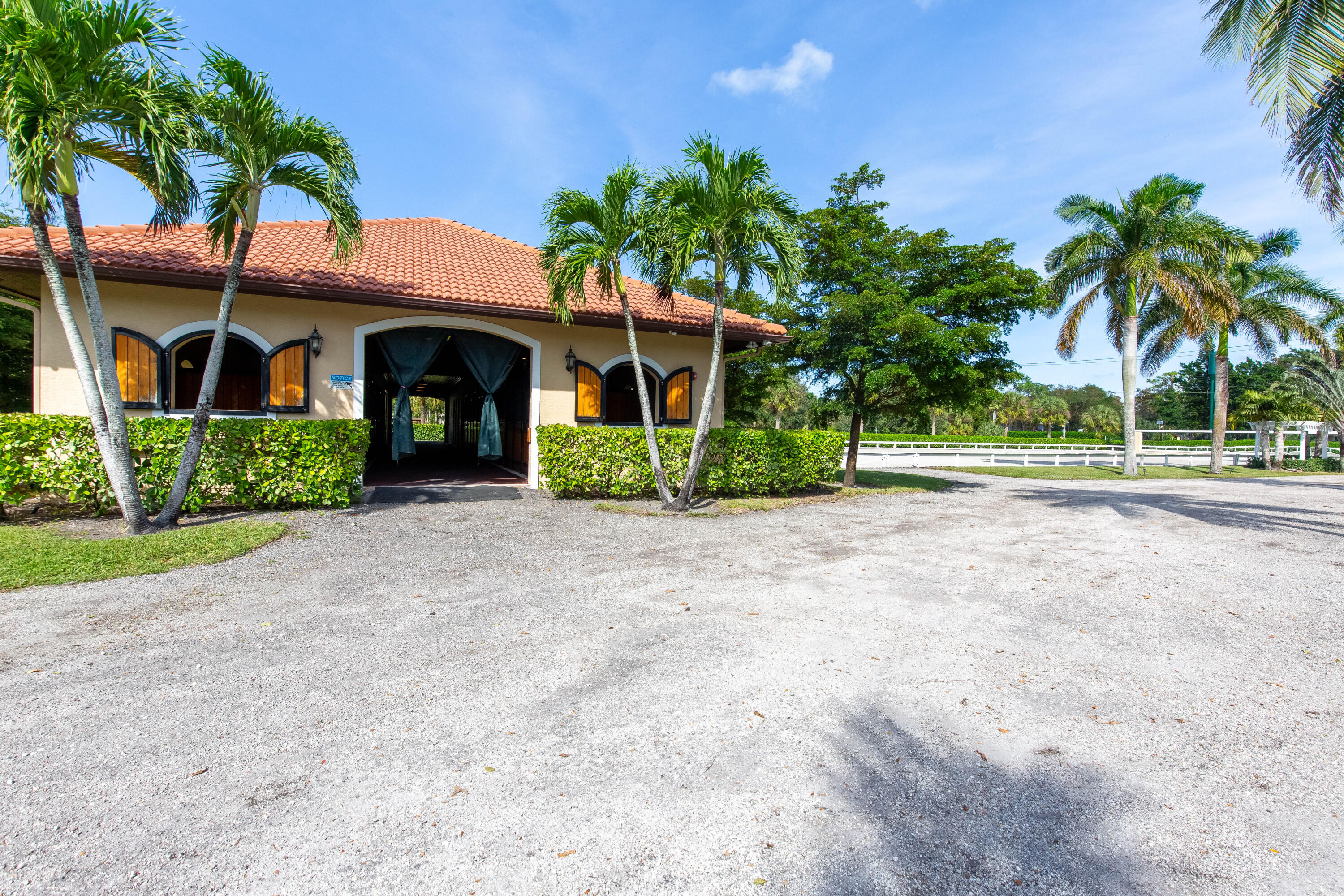 14943 Paddock Drive, Unit STALLS AND ) Wellington, FL 33414 - Photo 11 of 41 a front view of house with yard and green space