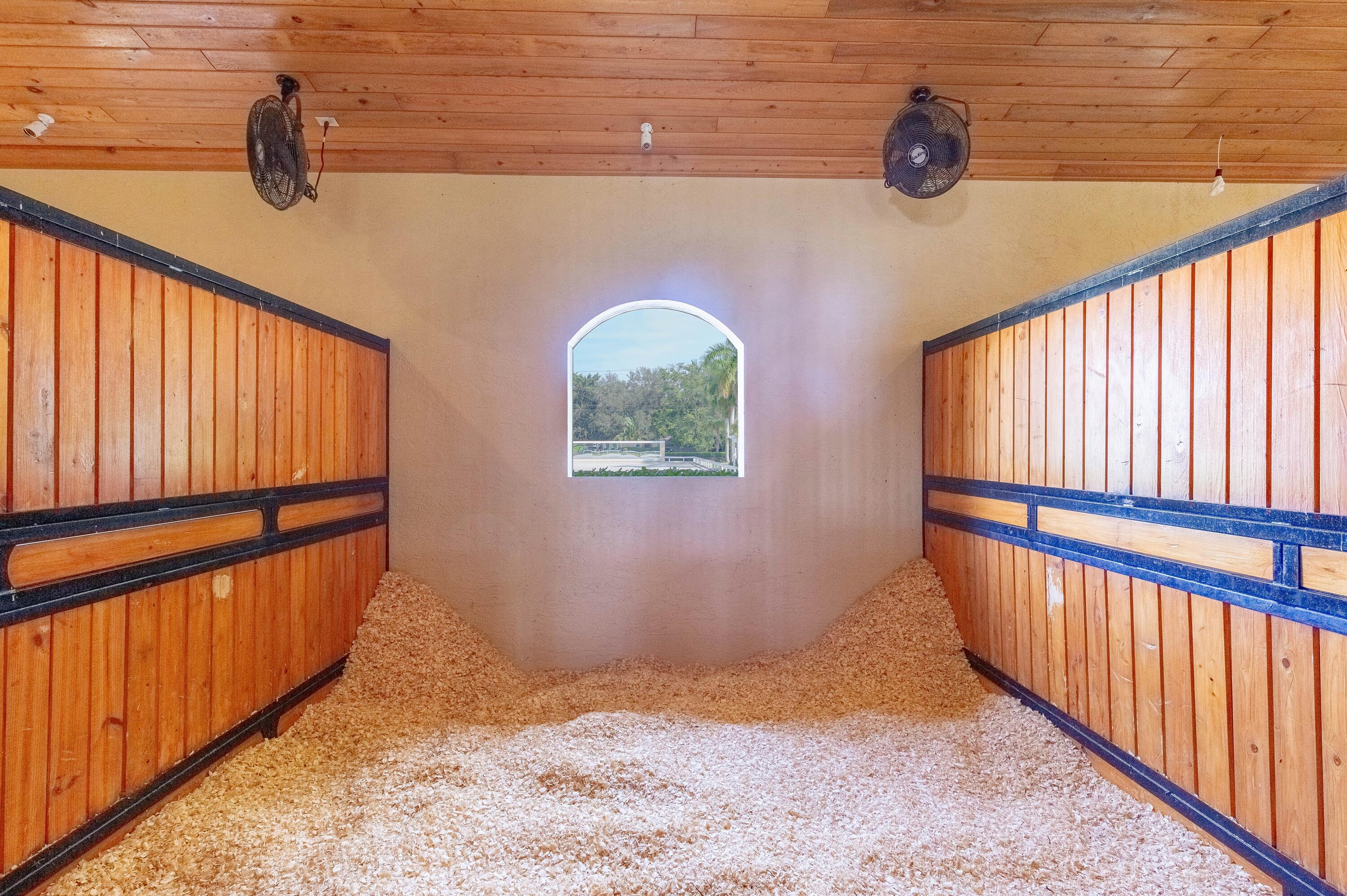 14943 Paddock Drive, Unit STALLS AND ) Wellington, FL 33414 - Photo 12 of 41 a view of a porch with wooden floor