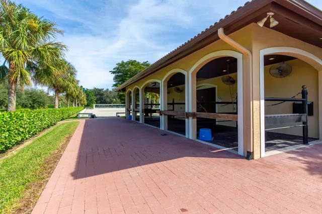 a view of a patio with a table and chairs next to a yard