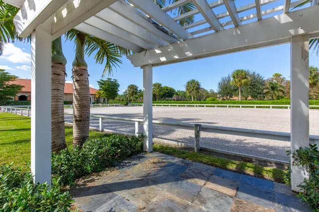 a view of a hallway with wooden floor and chandelier