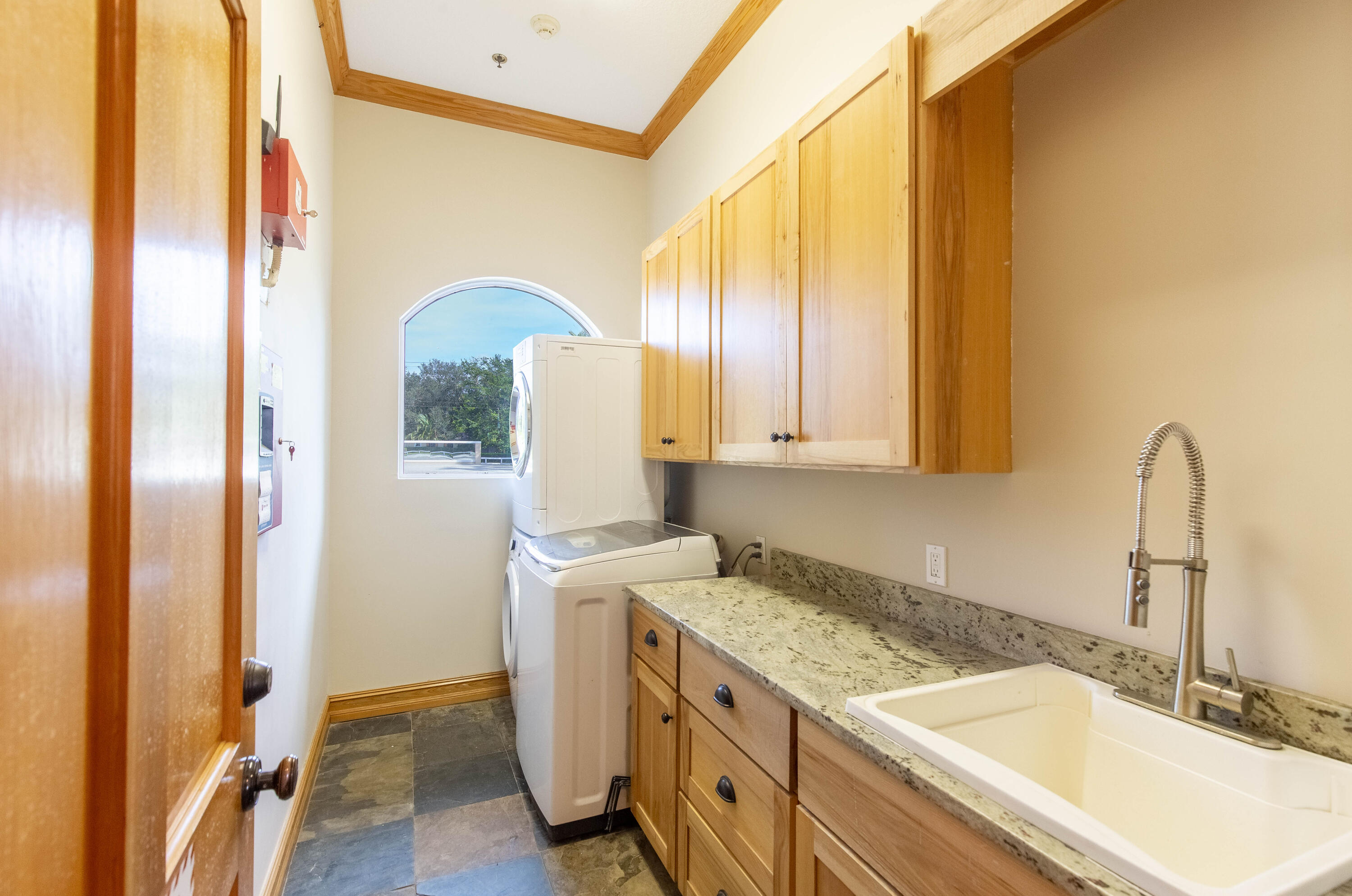14943 Paddock Drive, Unit STALLS AND ) Wellington, FL 33414 - Photo 24 of 41 a kitchen with a sink and a refrigerator