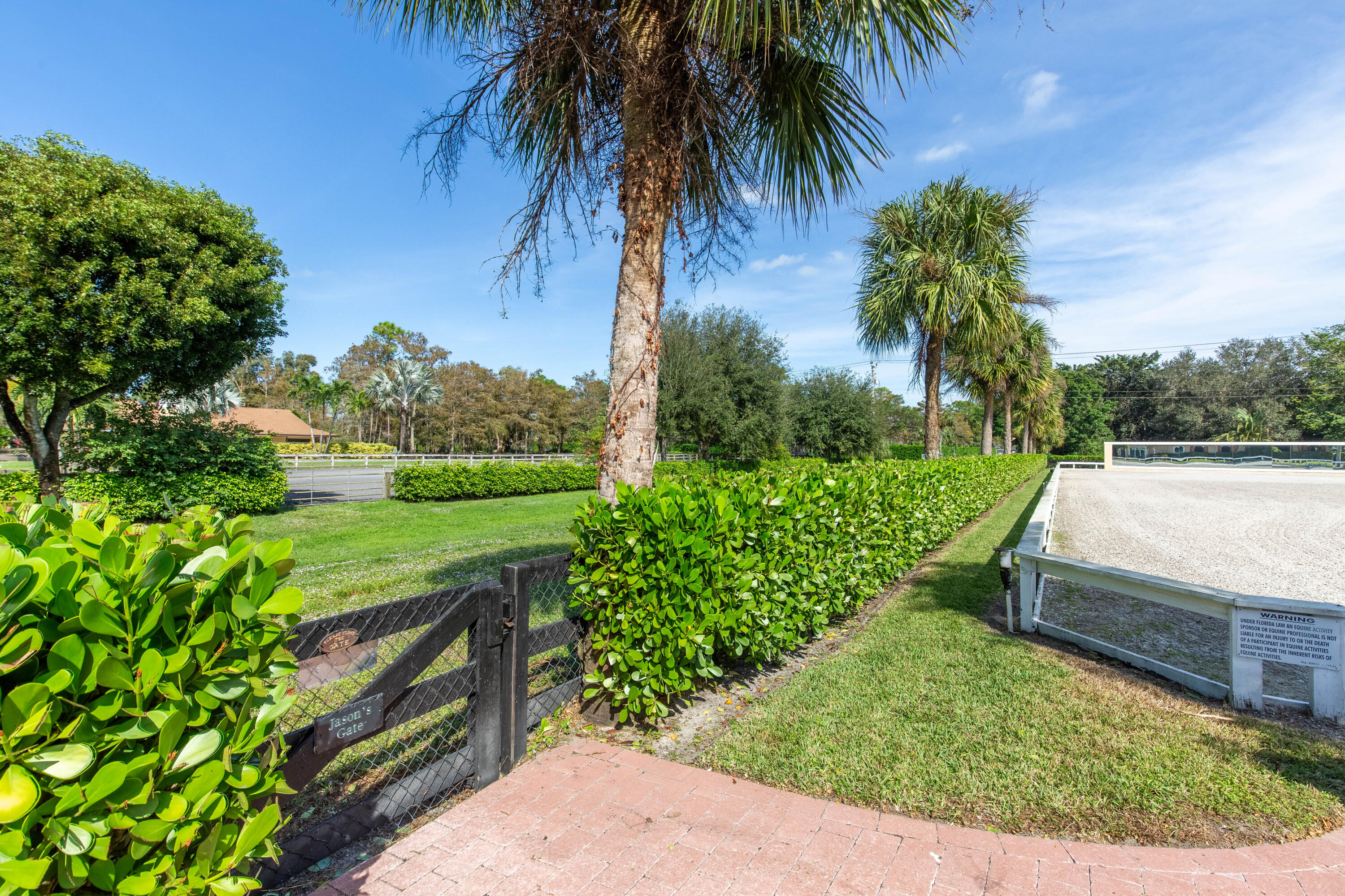 14943 Paddock Drive, Unit STALLS AND ) Wellington, FL 33414 - Photo 27 of 41 a view of a garden with palm trees