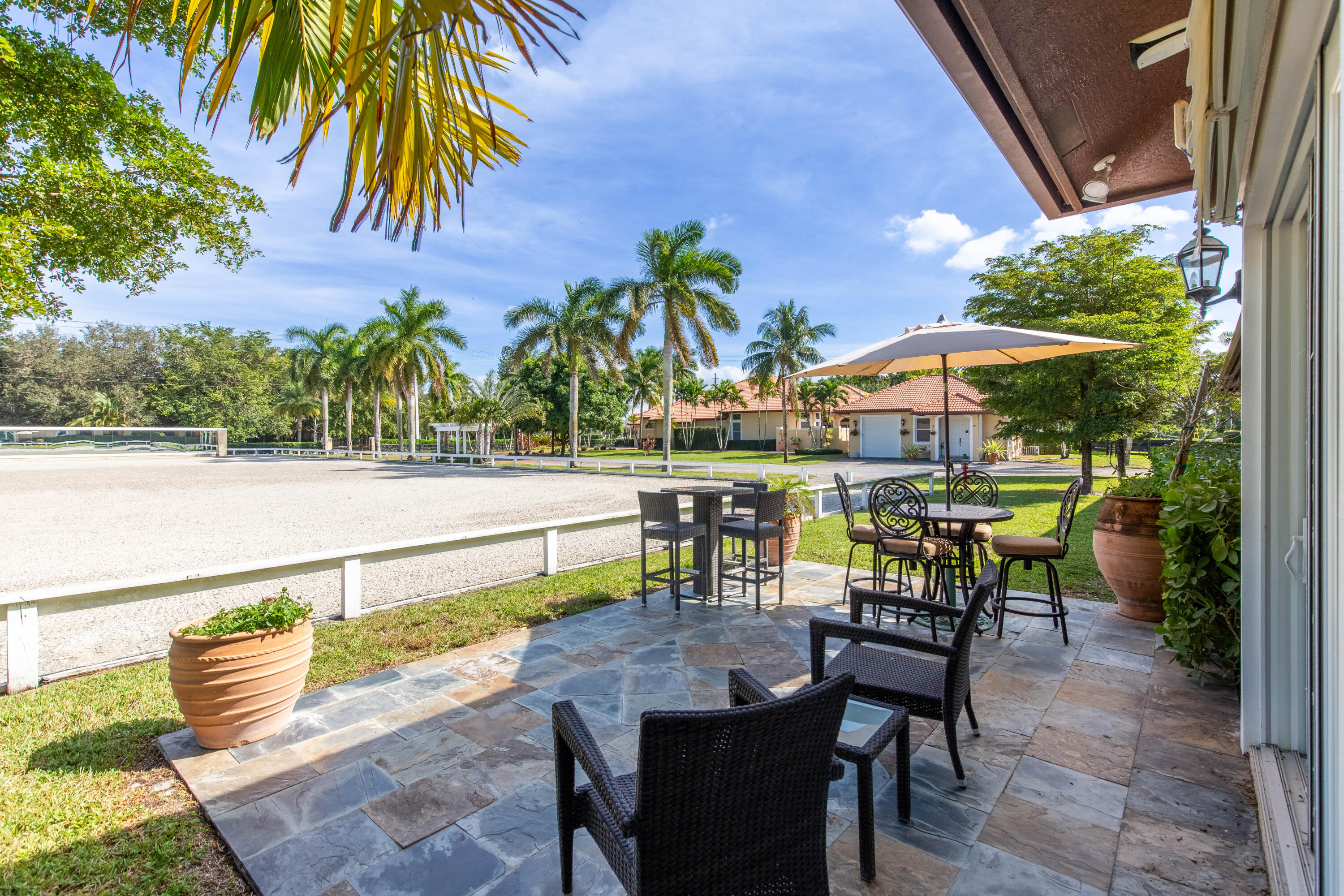 14943 Paddock Drive, Unit STALLS AND ) Wellington, FL 33414 - Photo 29 of 41 an outdoor space with furniture and umbrella