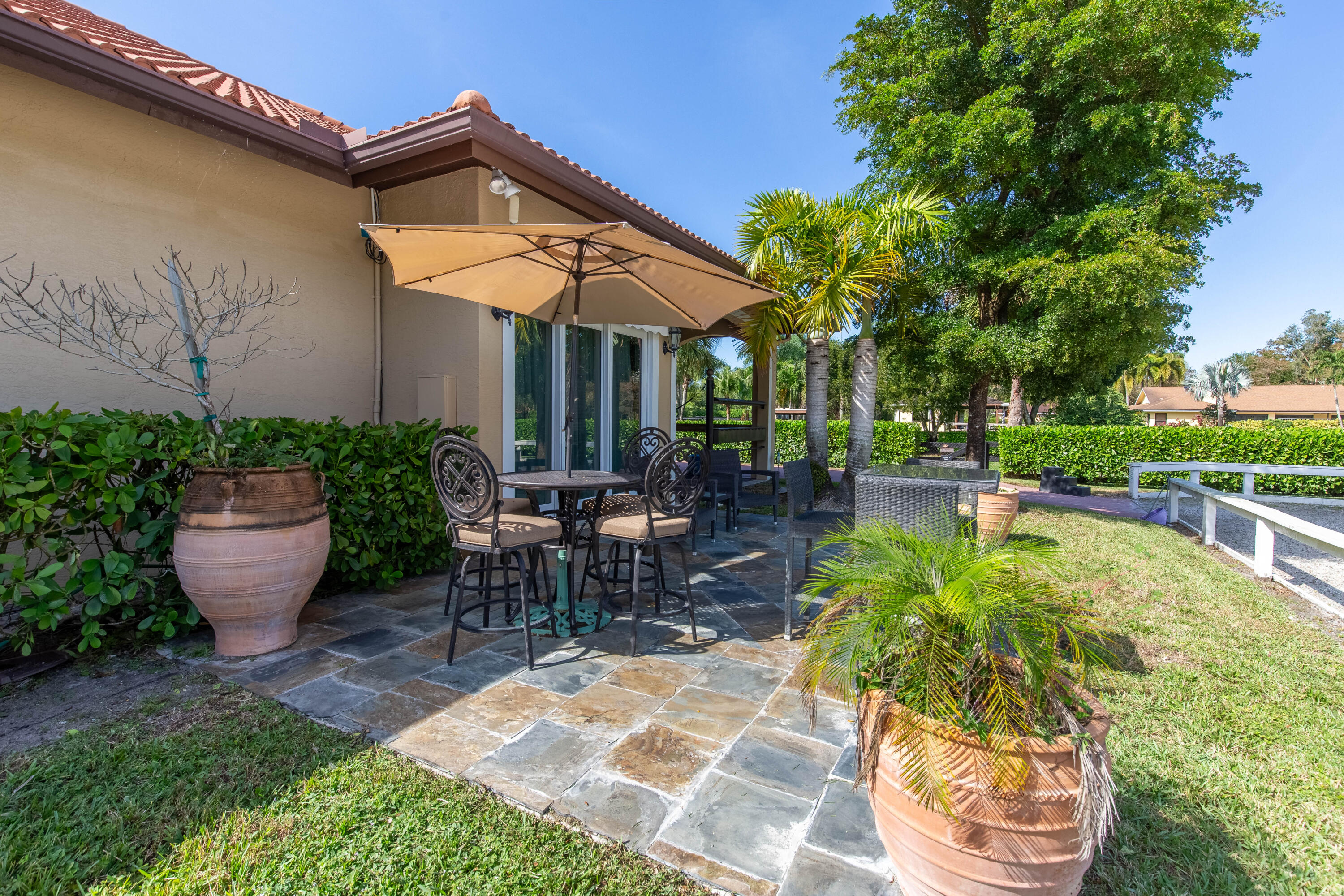 14943 Paddock Drive, Unit STALLS AND ) Wellington, FL 33414 - Photo 30 of 41 a view of a backyard with sitting area
