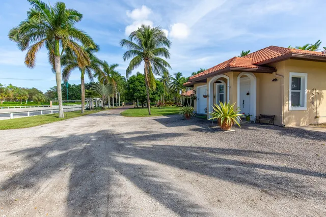 a front view of a house with a yard and a garage