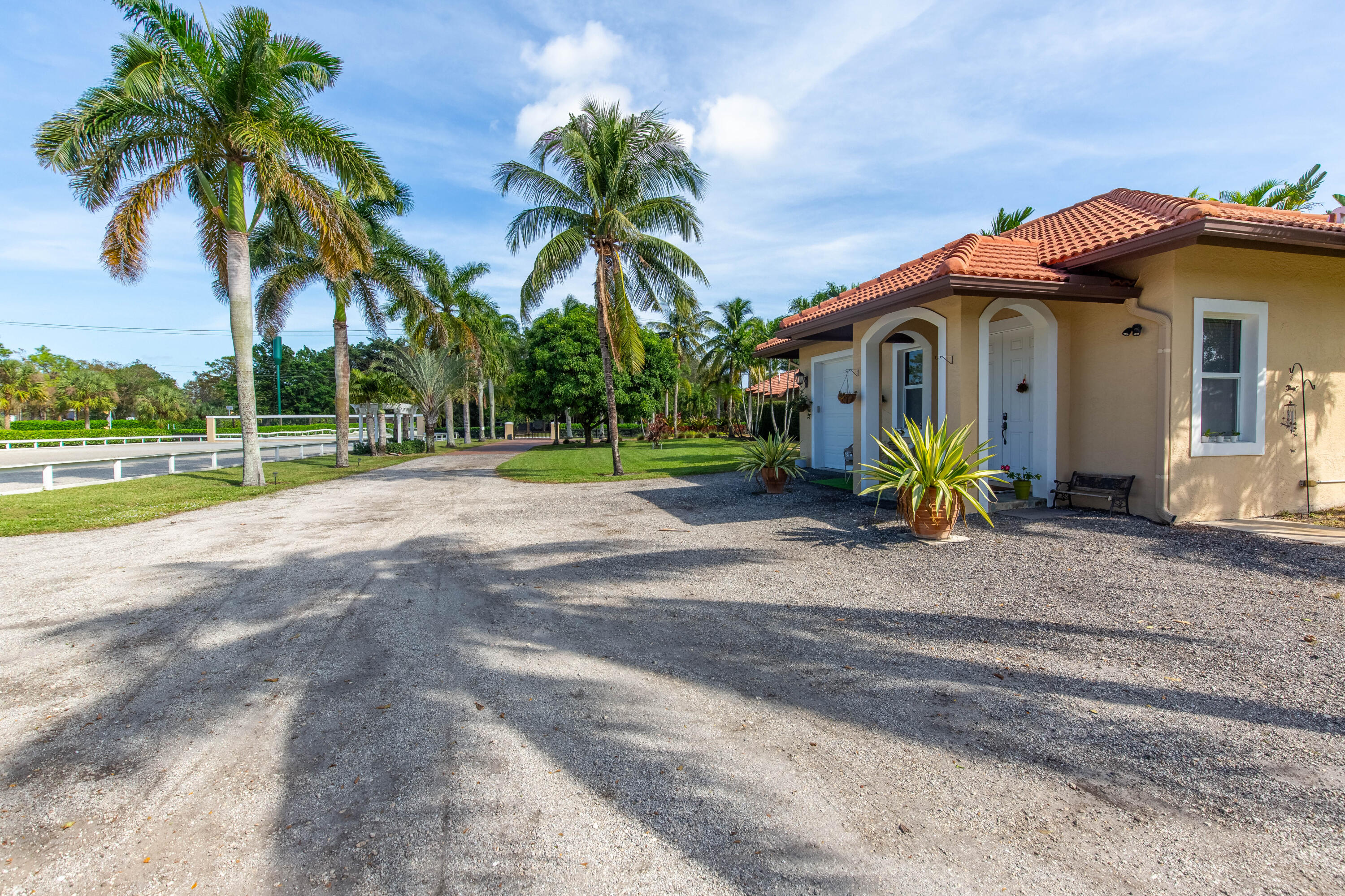 14943 Paddock Drive, Unit STALLS AND ) Wellington, FL 33414 - Photo 37 of 41 a front view of house with yard and green space