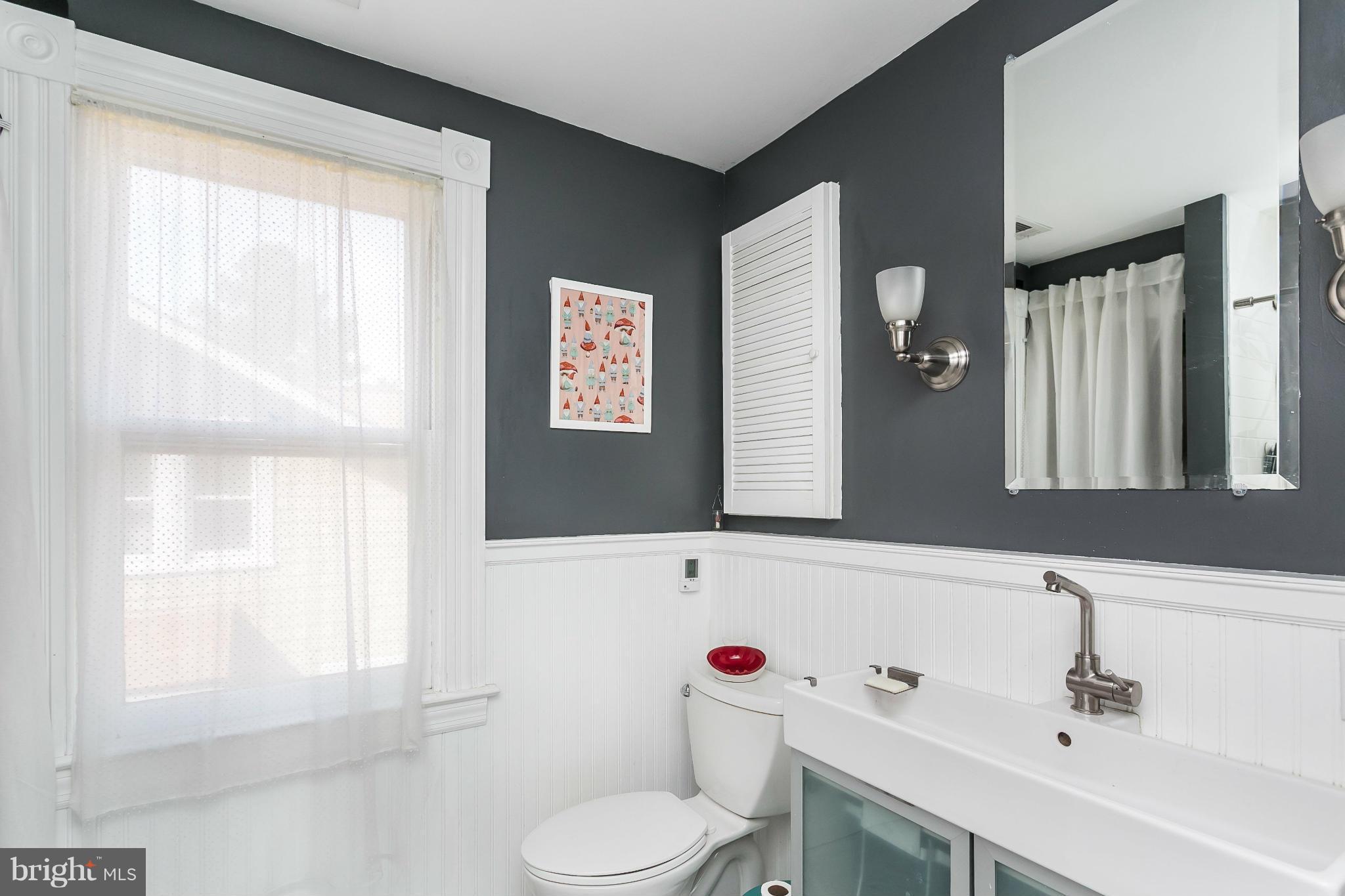 2807 Goodwood Road Baltimore, MD 21214 - Photo 22 of 30 a bathroom with a sink and a mirror