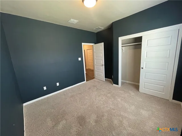 en empty room with closet and wooden floor