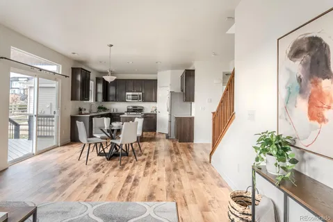 a view of a dining room with furniture and wooden floor