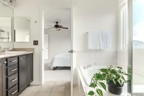 a bathroom with a tub sink and mirror