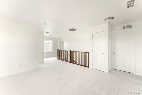 a view of a hallway with wooden shelves