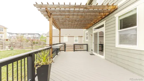 a front view of a house with swimming pool and furniture