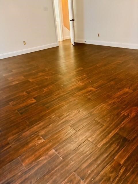 23915 Floragate Drive Spring, TX 77373 - Photo 11 of 25 an empty room with wooden floor and windows