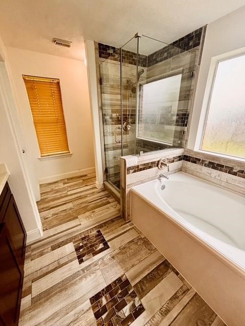 23915 Floragate Drive Spring, TX 77373 - Photo 12 of 25 a bathroom with a bathtub and a shower