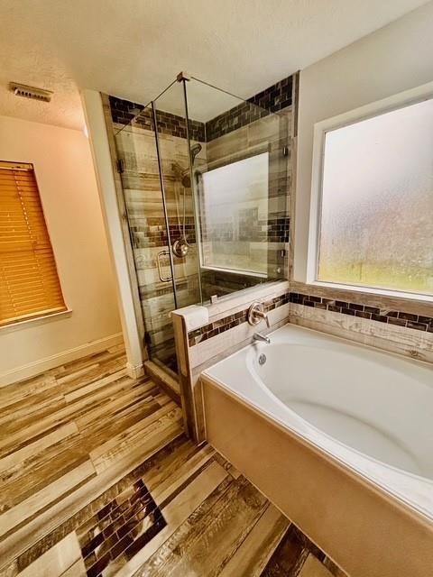 23915 Floragate Drive Spring, TX 77373 - Photo 20 of 25 a bathroom with a bathtub and a window