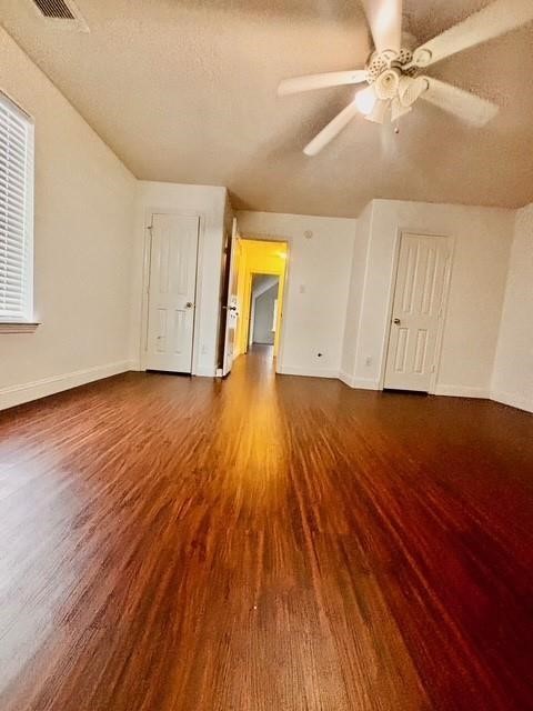 23915 Floragate Drive Spring, TX 77373 - Photo 23 of 25 an empty room with wooden floor and a ceiling fan
