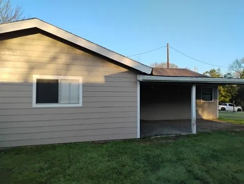 a backyard of a house with wooden floor and fence