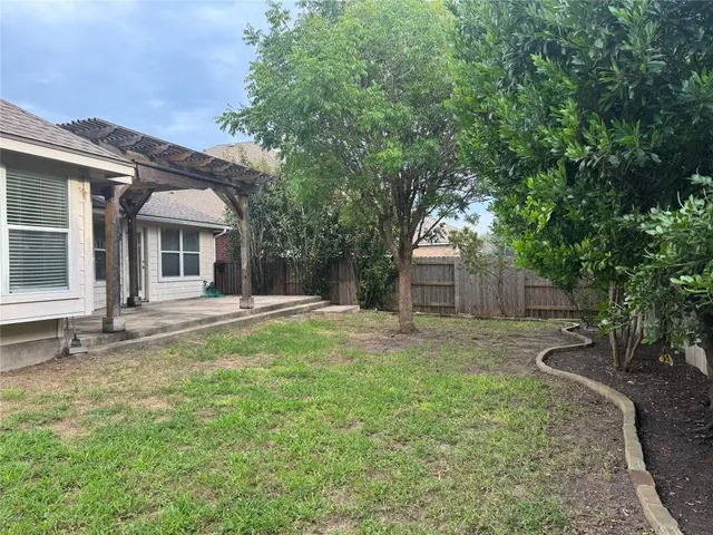 a backyard of a house with table and chairs