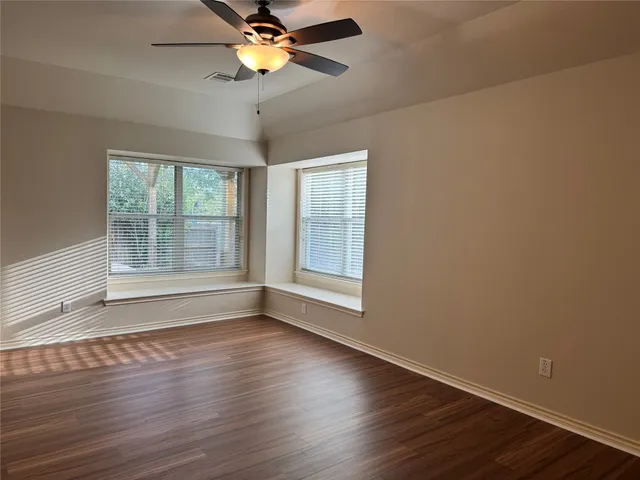 a view of wooden floor and windows in a room