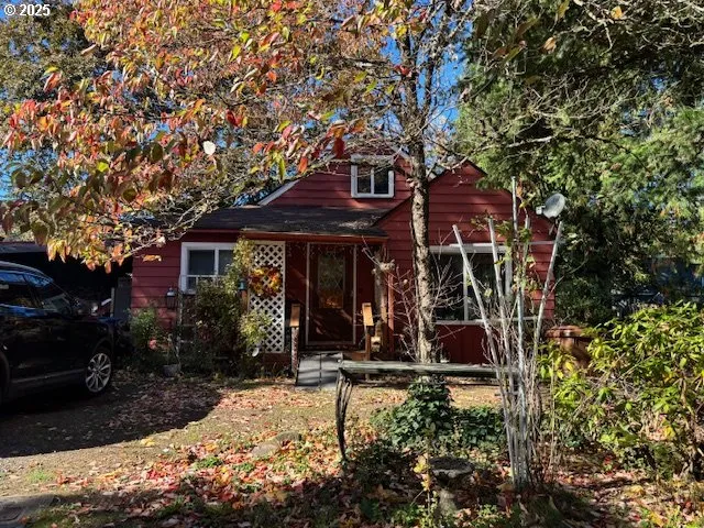 front view of a house with a tree