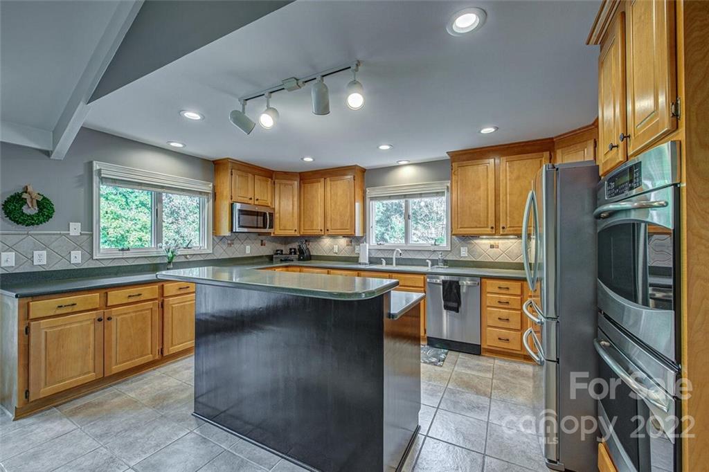 1909 3 Lakes Road Shelby, NC 28150 - Photo 12 of 48 a kitchen with stainless steel appliances granite countertop a sink counter space cabinets and a large window