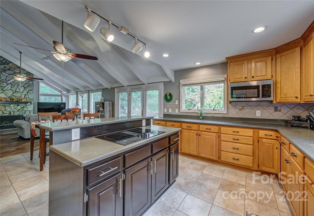 1909 3 Lakes Road Shelby, NC 28150 - Photo 16 of 48 a kitchen with stainless steel appliances granite countertop a large stove a sink dishwasher and cabinets with wooden floor