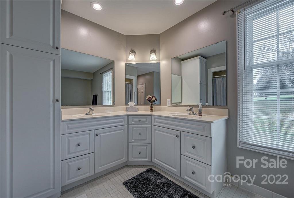 1909 3 Lakes Road Shelby, NC 28150 - Photo 23 of 48 a spacious bathroom with a double vanity sink a mirror and a shower