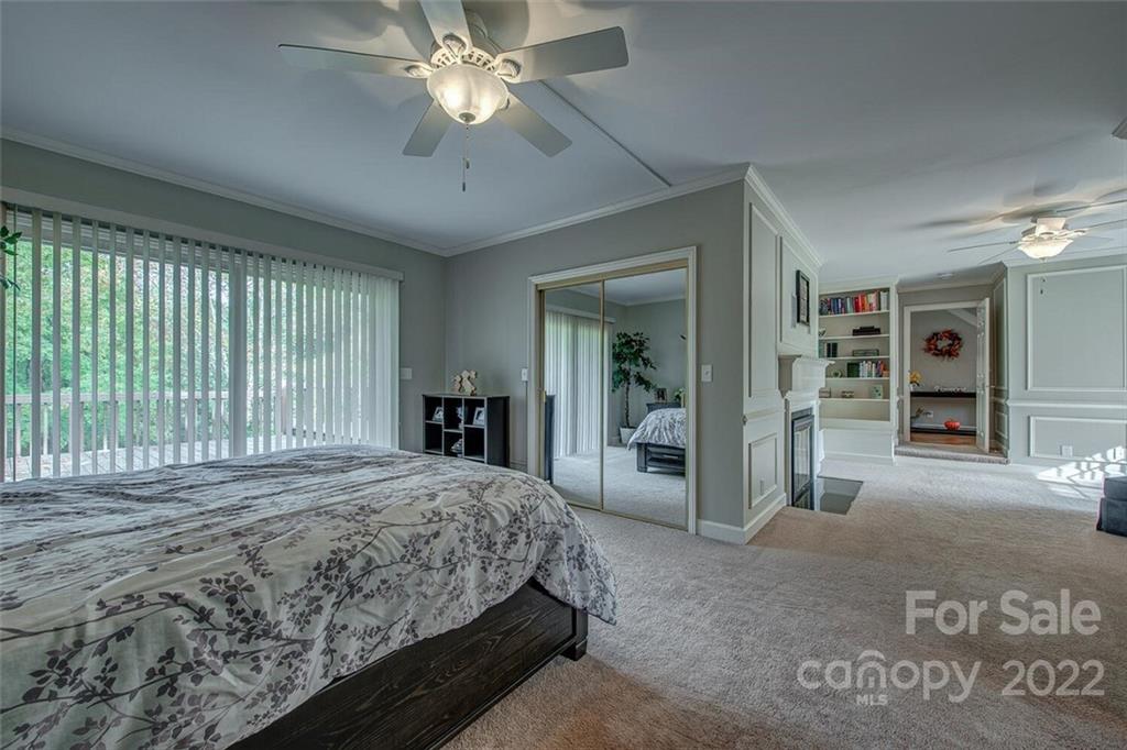 1909 3 Lakes Road Shelby, NC 28150 - Photo 26 of 48 a bedroom with a large bed and a chandelier