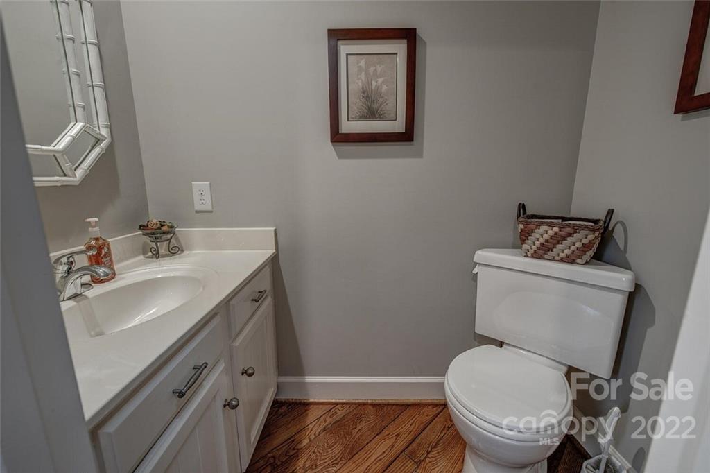 1909 3 Lakes Road Shelby, NC 28150 - Photo 27 of 48 a bathroom with a toilet sink vanity and mirror