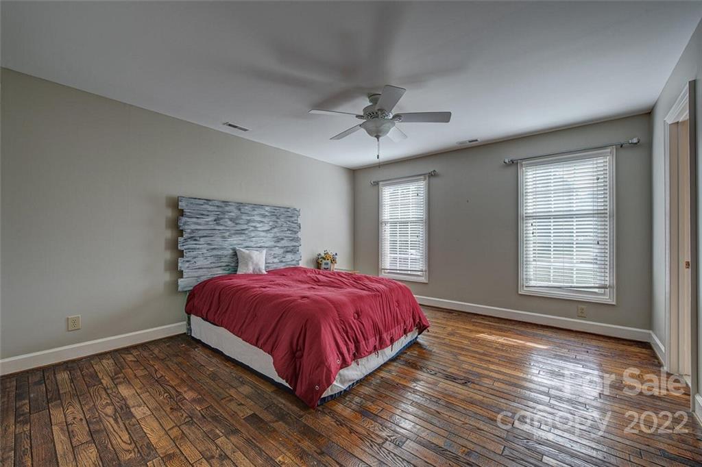 1909 3 Lakes Road Shelby, NC 28150 - Photo 29 of 48 a spacious bedroom with a bed and wooden floor