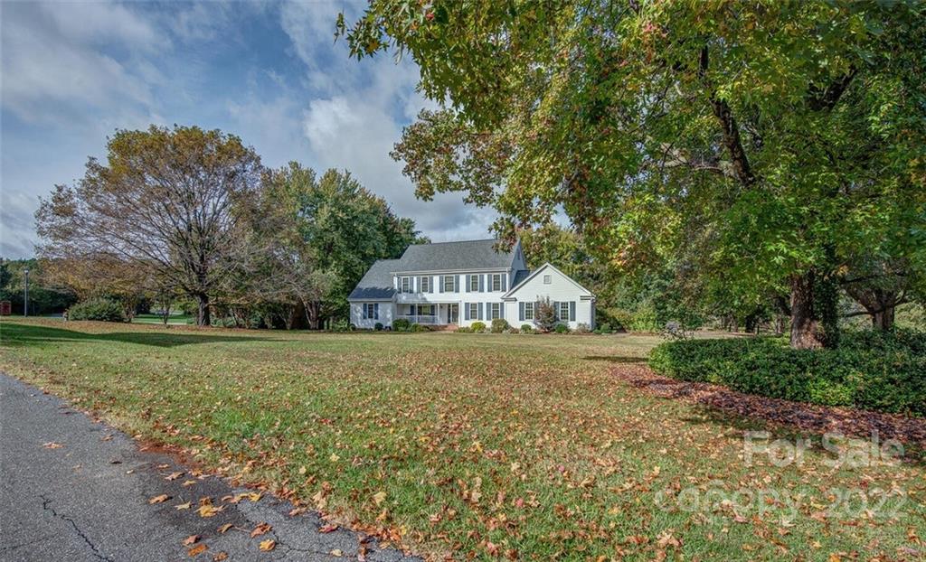 1909 3 Lakes Road Shelby, NC 28150 - Photo 3 of 48 a front view of a house with a garden and trees