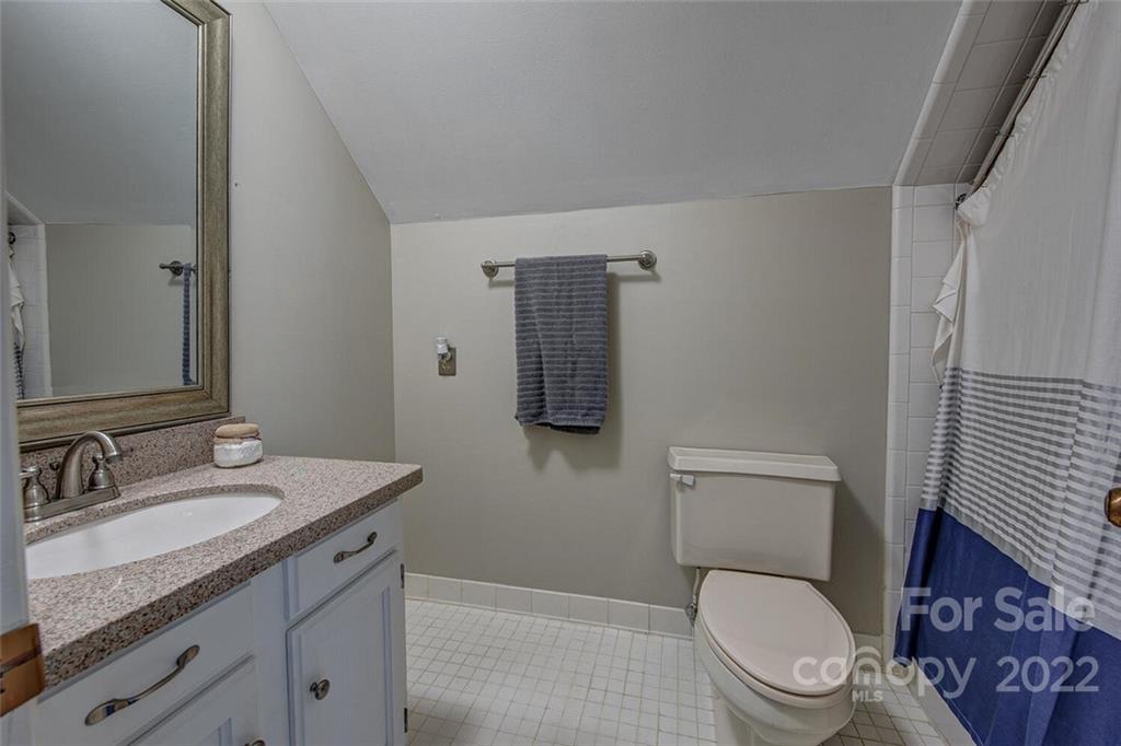 1909 3 Lakes Road Shelby, NC 28150 - Photo 34 of 48 a bathroom with a granite countertop toilet sink and mirror