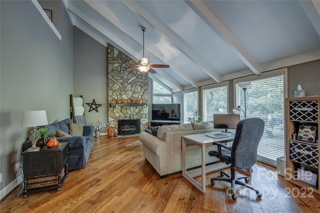 1909 3 Lakes Road Shelby, NC 28150 - Photo 7 of 48 a living room with furniture a fireplace a flat screen tv and a large window
