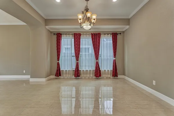 an empty room with windows and entrance