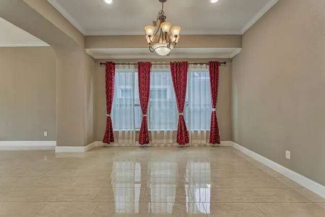 an empty room with windows and entrance