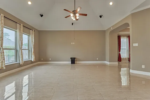 a view of a living room and chandelier fan kitchen view