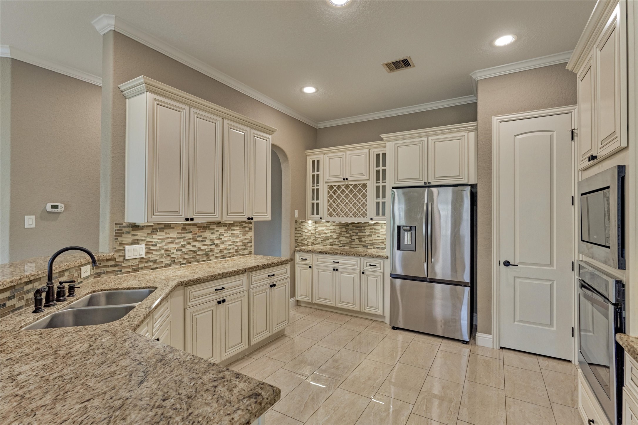 106 Bella Luce Shenandoah, TX 77381 - Photo 26 of 47 a kitchen with granite countertop a refrigerator and a sink