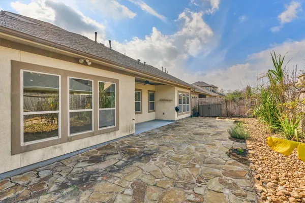 a view of an empty room with window and hardwood area
