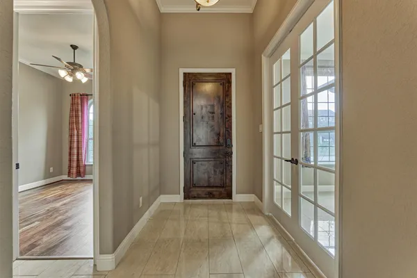 a view of a hallway with wooden floor and windows