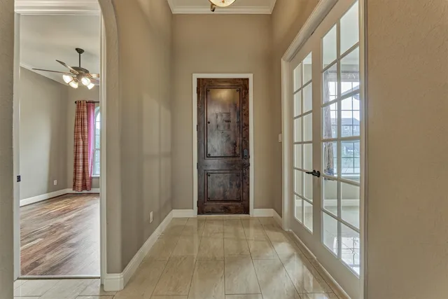 a view of a hallway with wooden floor and windows