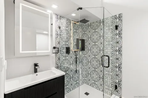 a bathroom with a shower and a sink