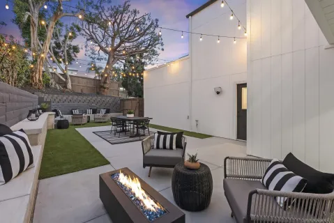a roof deck with couches and potted plants