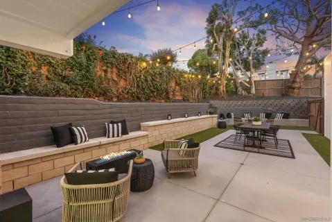 a backyard of a house with table and chairs