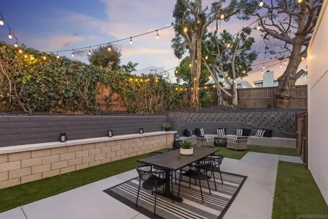 a front view of a house with garden and outdoor seating