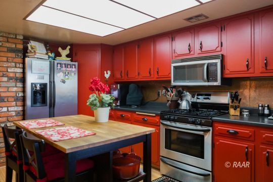 534 South Erin Street Ridgecrest, CA 93555 - Photo 10 of 29 a kitchen with stainless steel appliances a stove a microwave a sink and cabinets