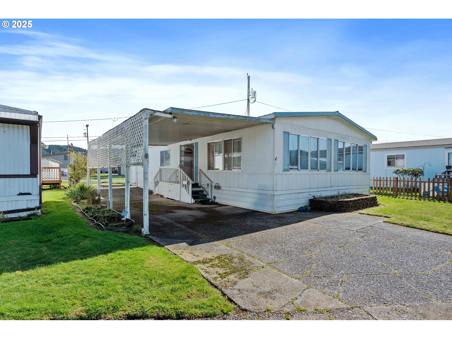 1413 Hawthorne Avenue, Unit 31 Reedsport, OR 97467 - Photo 1 of 16 a front view of a house with a yard